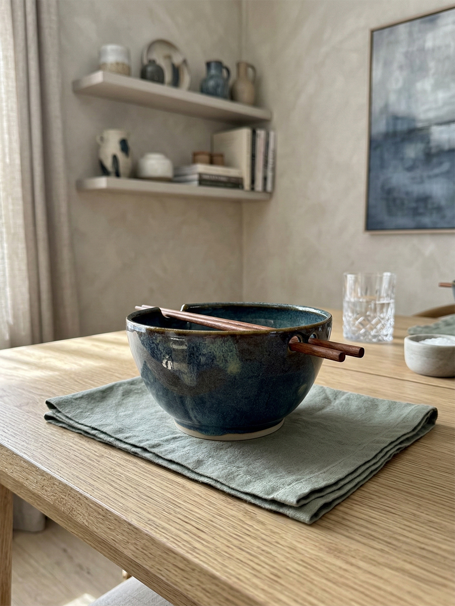 Dark blue glazed ramen bowl with a wooden chopstick rest
