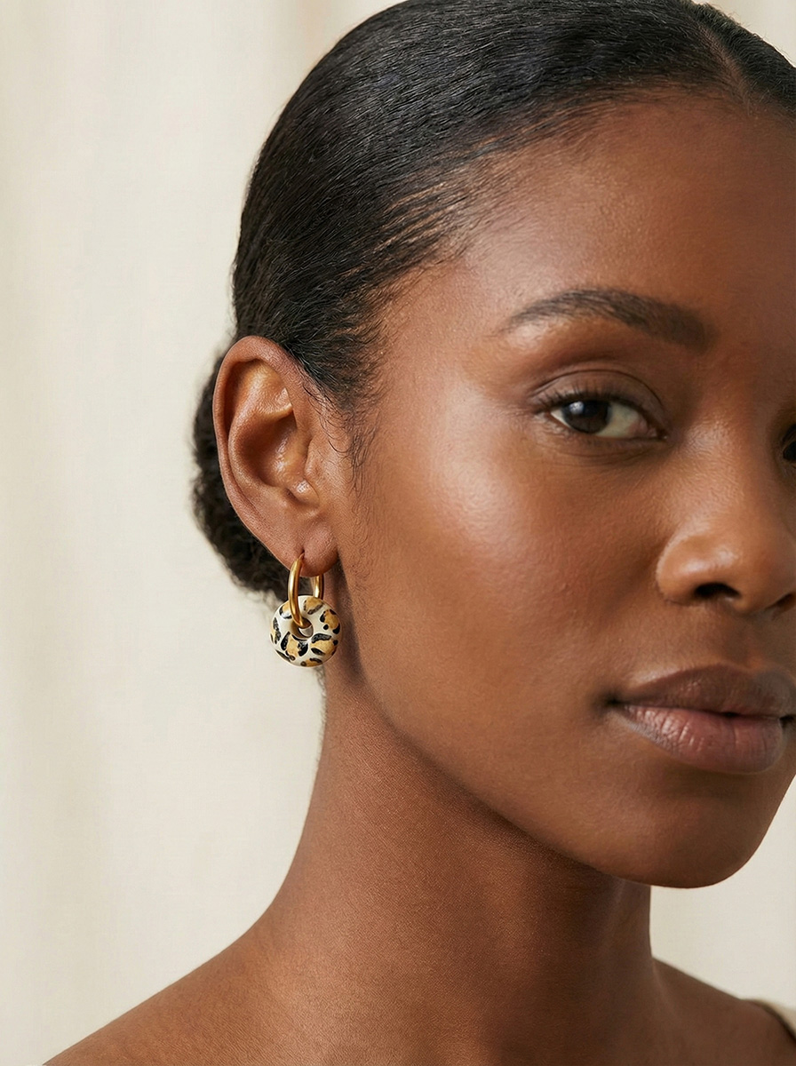 Gold hoop earring with a leopard-print ceramic donut